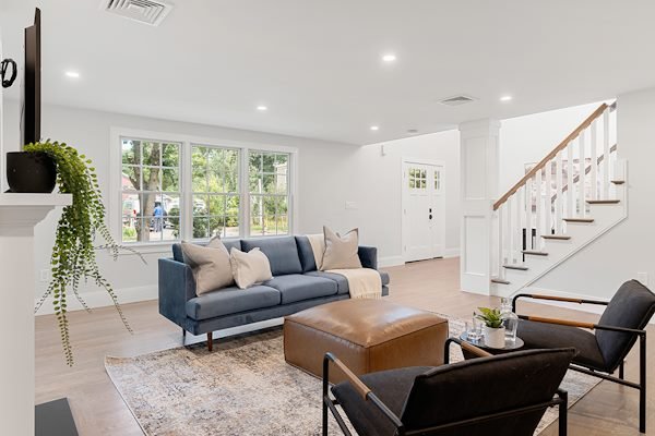 Contractor renovating open plan living space during full home remodeling project